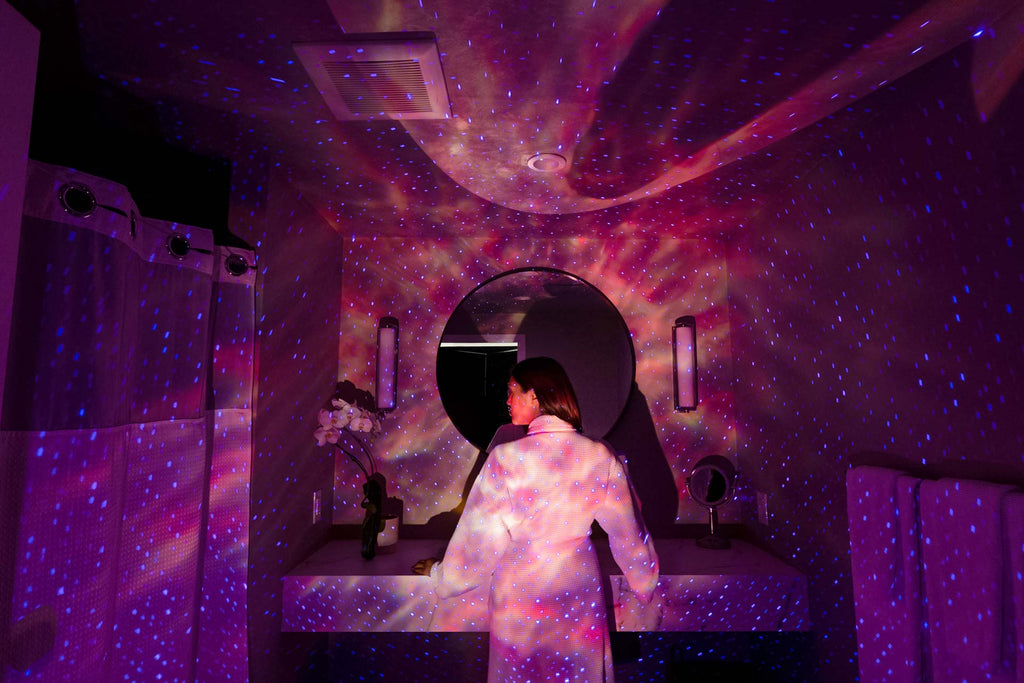 woman standing in front of mirror with pink galaxy lights, sky lite evolve