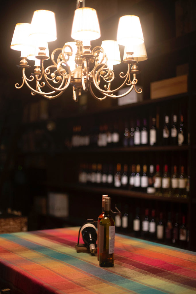 chandelier over bottles in wine cellar