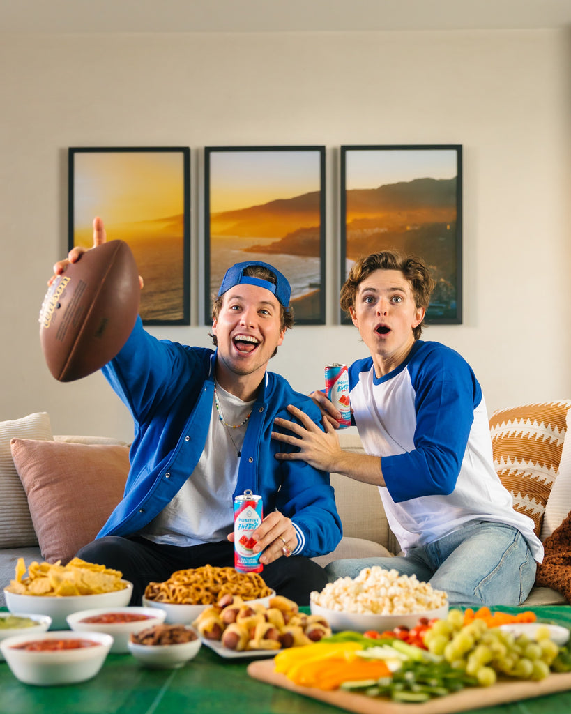 men cheering with super bowl snacks