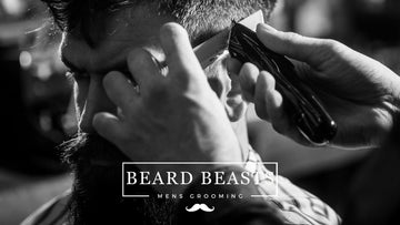 A professional barber trimming a man's beard in a barber shop, illustrating the precision and care taken in men's grooming — a perfect example of how to find a good barber shop.