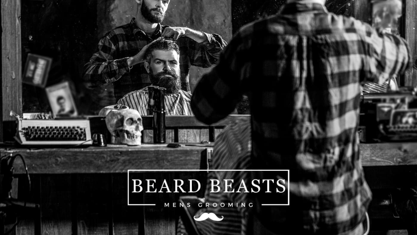 A bearded man getting groomed in a vintage barber shop, reflecting the classic experience one might seek when learning how to find a good barber shop.