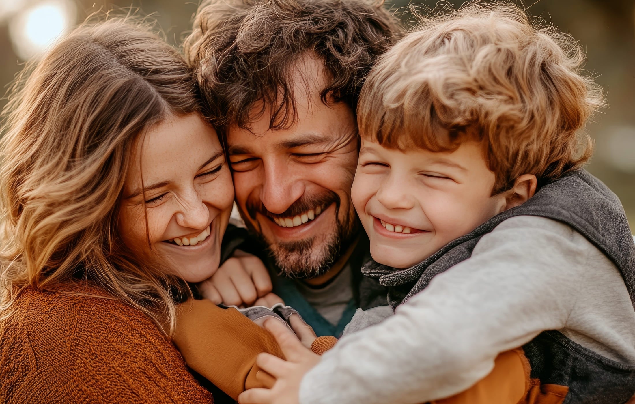 Close-up of a happy family sharing a warm embrace, smiling and radiating joy, highlighting the importance of love, connection, and togetherness.