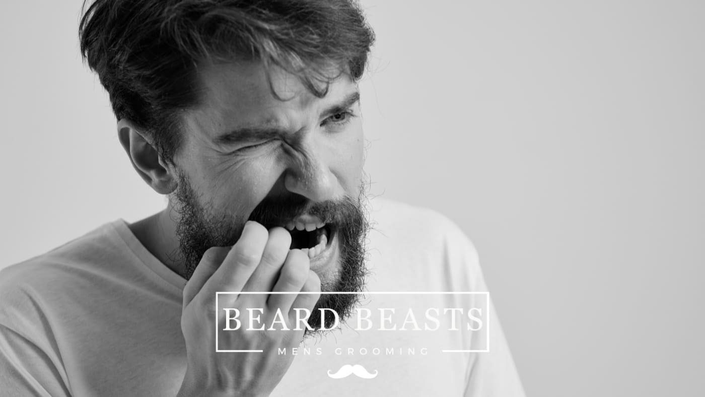 Man experiencing beard pain, grimacing and holding his facial hair,