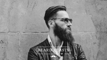 Stylish man with sunglasses and a well-groomed beard, exemplifying how to maintain a beard in an urban setting.