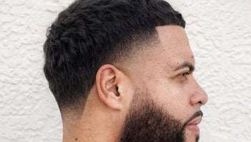 Side profile of a man with a stylish French Crop Taper haircut, featuring a textured top and a smooth taper fade on the sides and back.