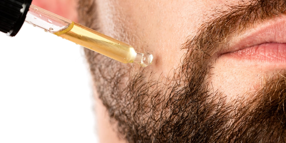 man applying beard oil wondering are beard oils worth it