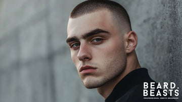 A sharp and clean profile of a young man showcasing a Bald Fade Buzz Cut, featuring a smooth transition from the shaved sides to the short, textured top.