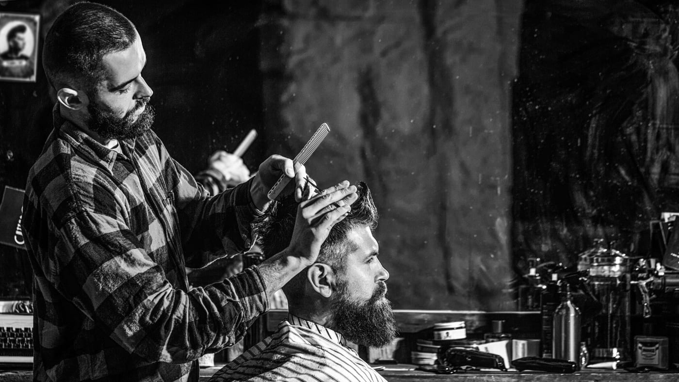 "Barber meticulously crafting a crew cut for a client who wondered how to ask for a crew cut