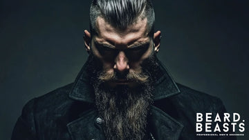 An intense portrait of a man displaying one of the best beard styles, featuring a full, thick Viking beard. 