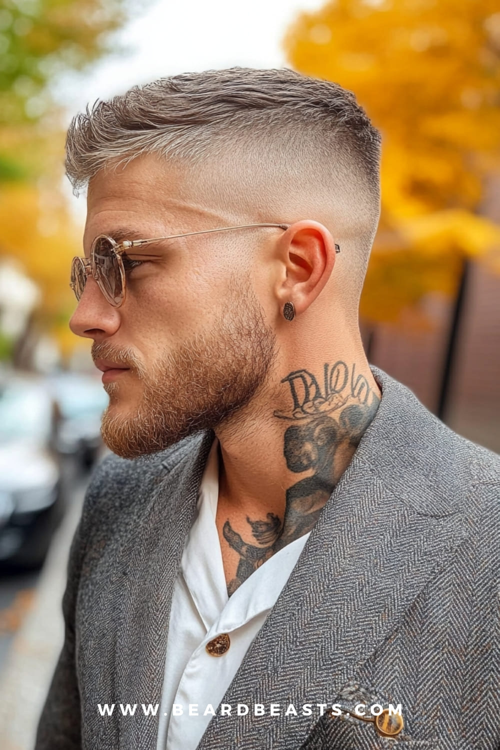 Side profile of a man with a sharp crew cut, wearing glasses and a suit jacket, highlighting a trendy yet practical hairstyle. The crew cut is one of the best low maintenance haircuts for men, offering a clean, stylish look that requires minimal daily grooming