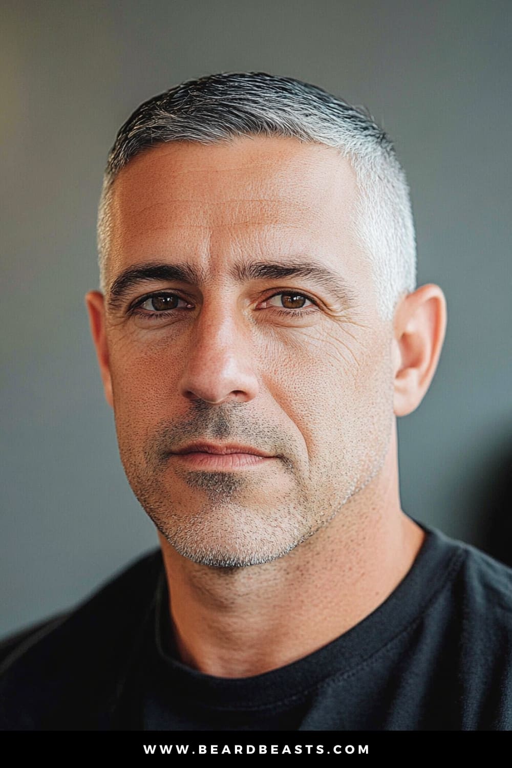 A mature man with a well-maintained salt-and-pepper hairstyle, showcasing a Crew Cut, a classic and popular choice among short hairstyles for older men. His hair is short on the sides and back, with slightly more length on top, creating a clean, sharp look that enhances his facial features. The neutral background emphasizes the simplicity and timelessness of this haircut, making it ideal for those seeking a low-maintenance yet stylish appearance. This image captures the essence of the Crew Cut, a versatile option that suits men looking for a neat, polished look in their later years.