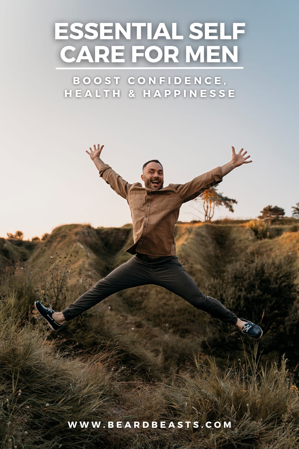 A happy man jumps outdoors in a scenic, grassy landscape, looking excited and carefree. The text on the image reads, "Essential Self-Care for Men: Boost Confidence, Health & Happiness," promoting self-care for men. The website URL "www.beardbeasts.com" is also displayed at the bottom.