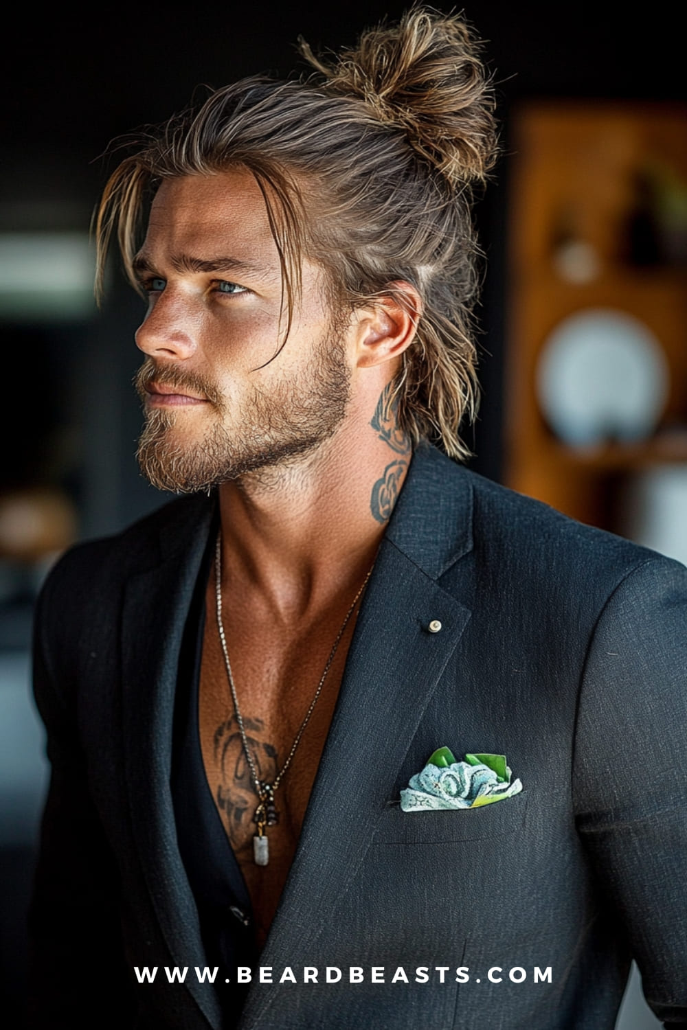 Man Bun Hairstyle - A stylish and rugged gentleman's haircut featuring long hair pulled back into a man bun, paired with a well-groomed beard. Perfect for a casual yet sophisticated look.