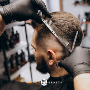 a man in a barber shop getting a number 1 fade haircut