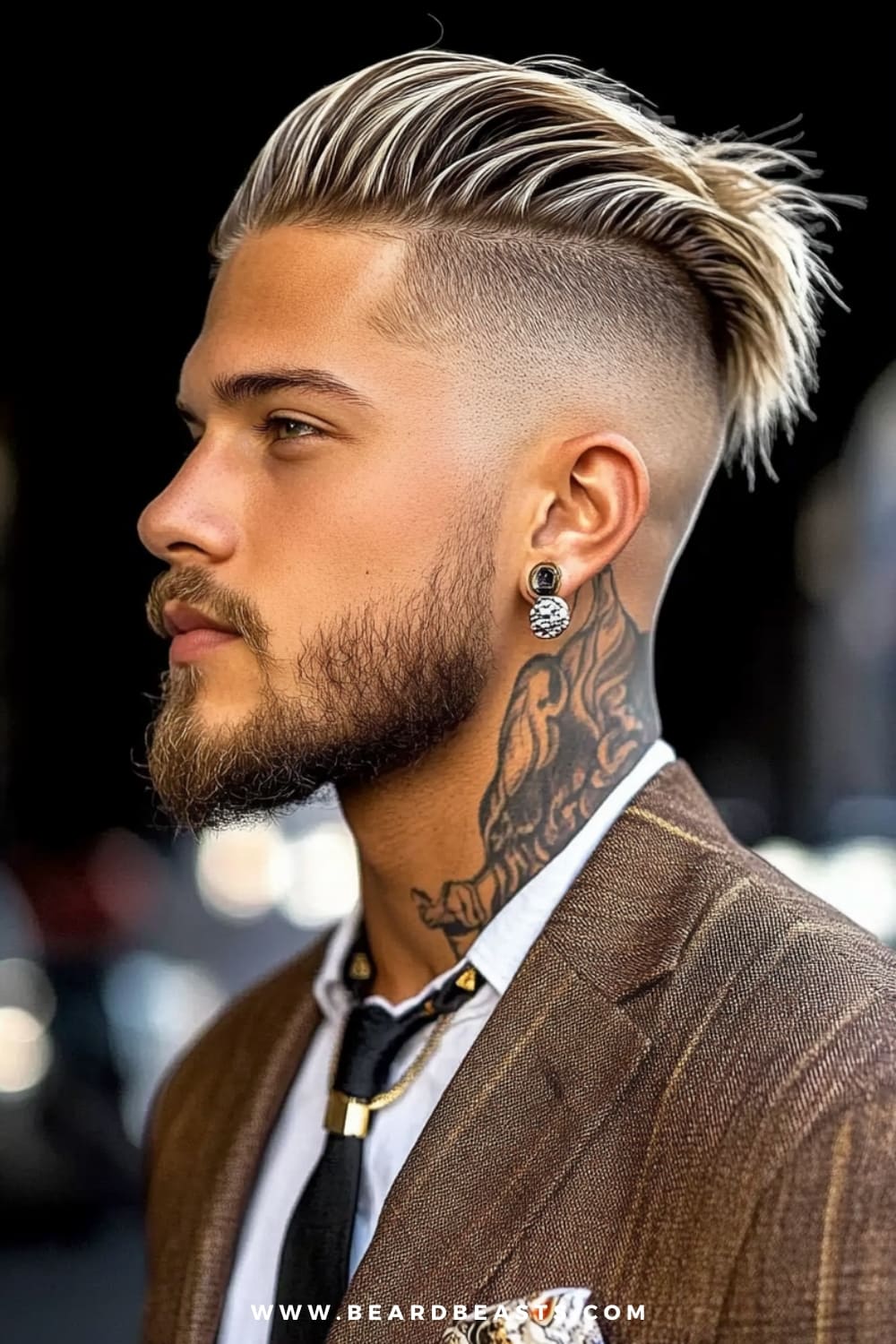 Man rocking a slicked-back undercut, with platinum blonde highlights and a high skin fade, creating a sharp contrast between the voluminous top and shaved sides. The hairstyle is edgy yet polished, making it perfect for formal occasions with a modern twist. Complemented by a well-groomed beard, earrings, and visible neck tattoos, this look is a bold representation of contemporary men's formal hairstyles, blending individuality with elegance.