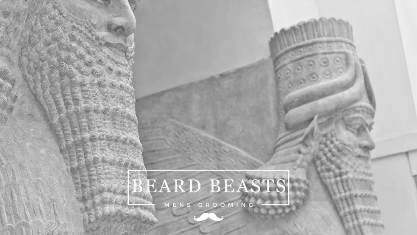 two old statues of bearded men, showcasing the history of the beard