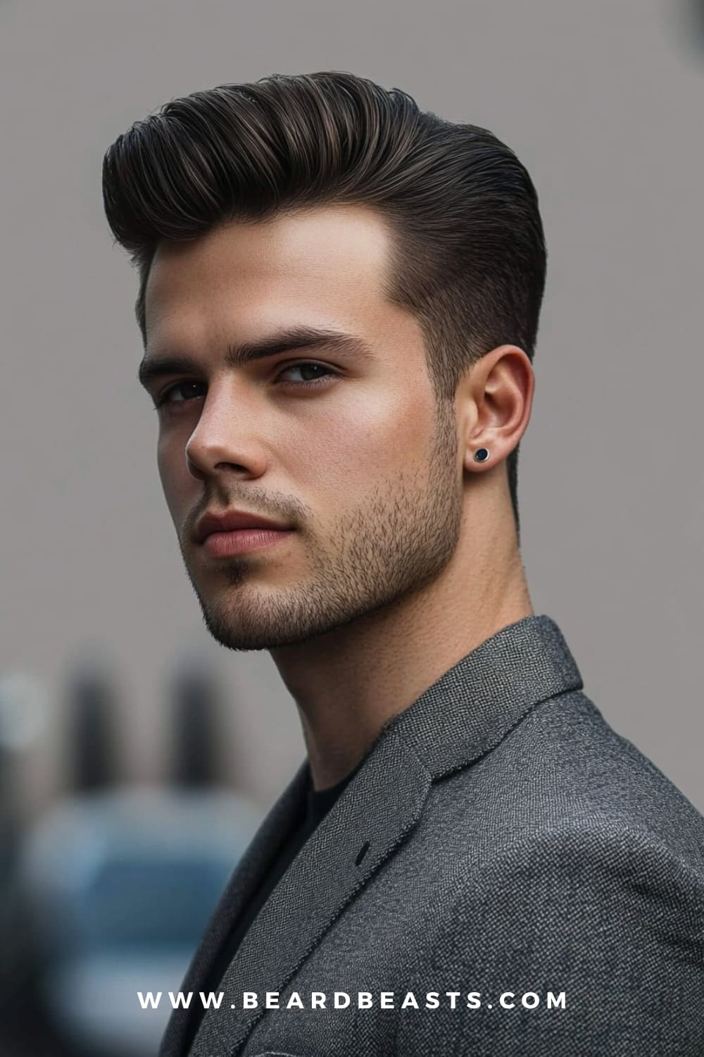 Side view of a man with a voluminous pompadour hairstyle and light stubble. This is one of the best medium-length hairstyles for men with round faces, as the height adds length to the face, while the sleek sides provide a balanced and refined look. Perfect for enhancing facial structure.