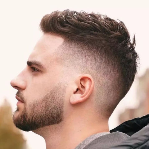 Side profile of a man with a Short Quiff haircut, featuring voluminous, textured hair on top styled upwards and back, complemented by a clean fade on the sides. The well-defined quiff adds height and movement, creating a modern, stylish look that's perfect for both casual and formal occasions.