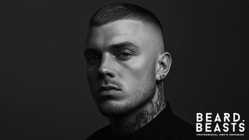 Black and white portrait of a man with a sharp skin fade crew cut, featuring clean, closely cropped sides that taper into the skin with precision.