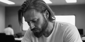 Stressed man deep in thought, highlighting the need for effective stress management techniques for men to improve mental health and achieve stress relief.