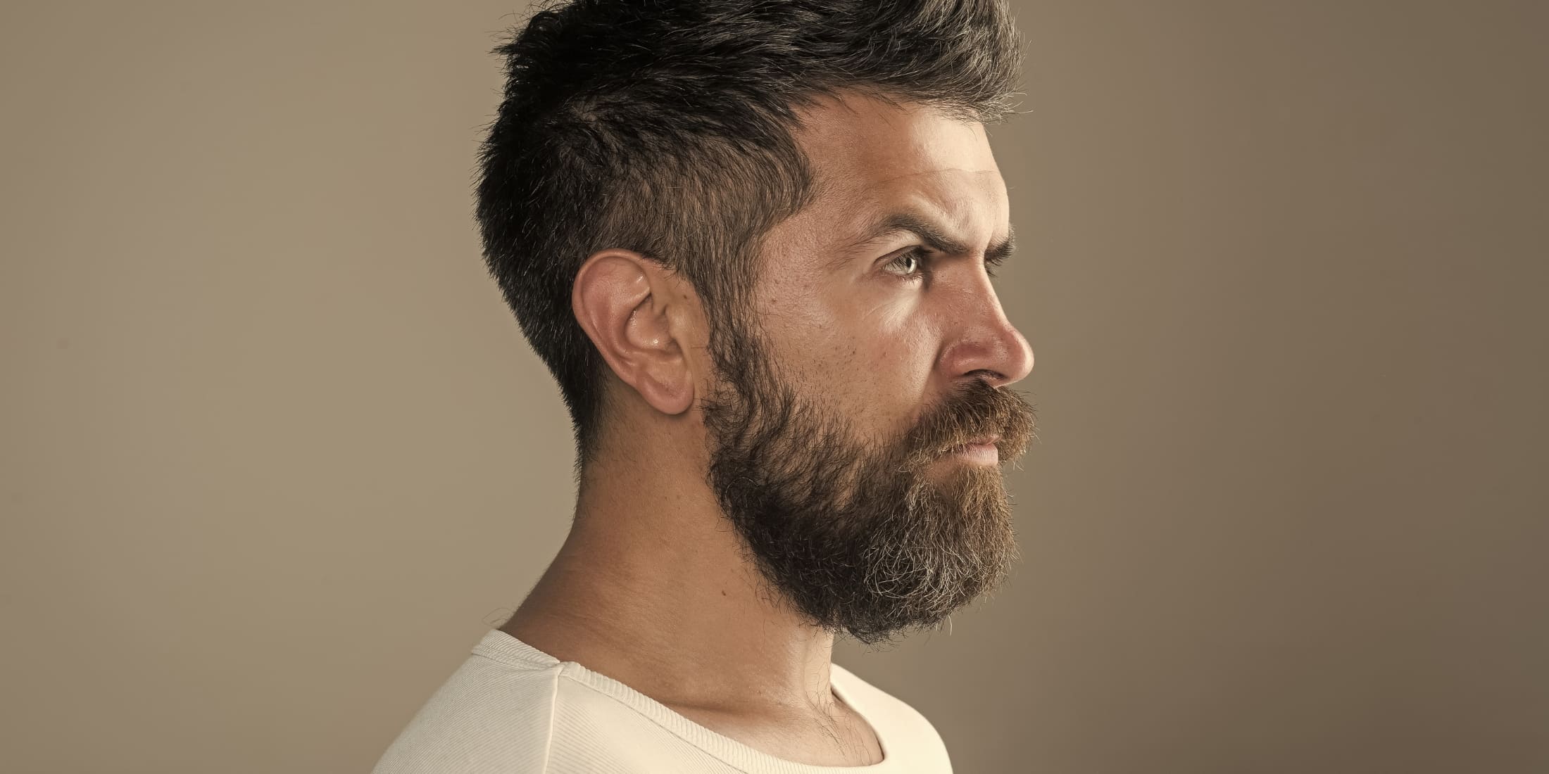 Man with a taper haircut, highlighting the difference in fade vs taper styles.