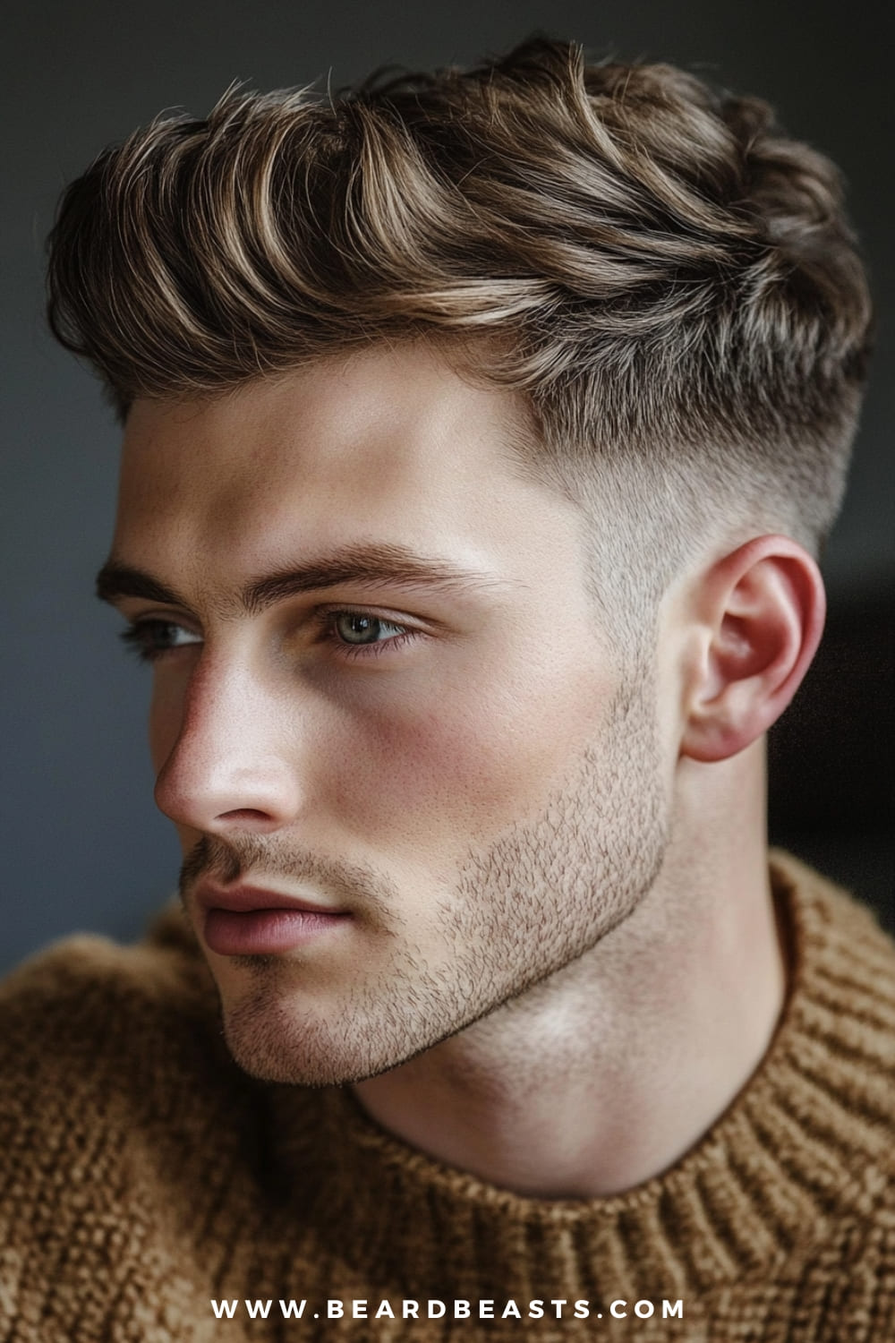 A young man is sporting a Textured Quiff, one of the popular medium length hairstyles for men that exudes a modern and stylish vibe. His hair is skillfully styled with volume at the top, featuring soft waves that add texture and movement, while the sides are neatly faded to create a sharp contrast. This hairstyle is perfect for those who prefer a polished yet slightly tousled look, blending sophistication with a casual edge. He’s wearing a cozy brown sweater, which complements the warm tones of his hair, adding to his overall suave and contemporary appearance.