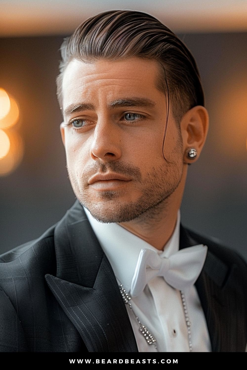 A groom with a sophisticated Slicked Back hairstyle, a popular choice among men's wedding hairstyles. His hair is perfectly combed back, creating a sleek and polished look that pairs elegantly with his classic black tuxedo, white bow tie, and subtle jewelry. The soft lighting enhances his sharp features and thoughtful expression, making this style ideal for a formal wedding setting. The overall look exudes confidence, elegance, and timeless charm, perfect for a memorable wedding day.