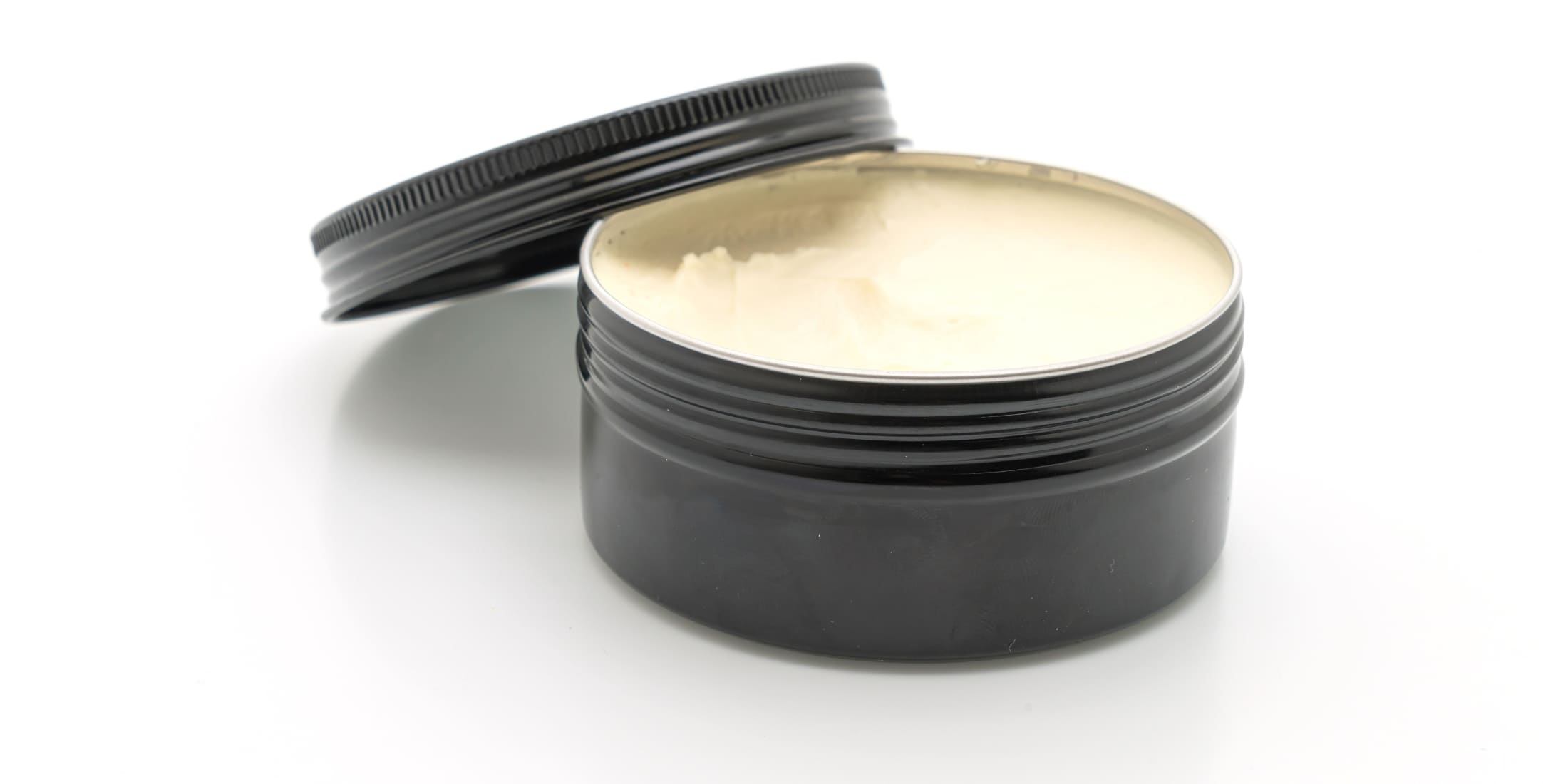 Open tin of hair pomade showing creamy texture - Hair Putty vs Pomade comparison, best hair styling products for men, matte finish vs high shine