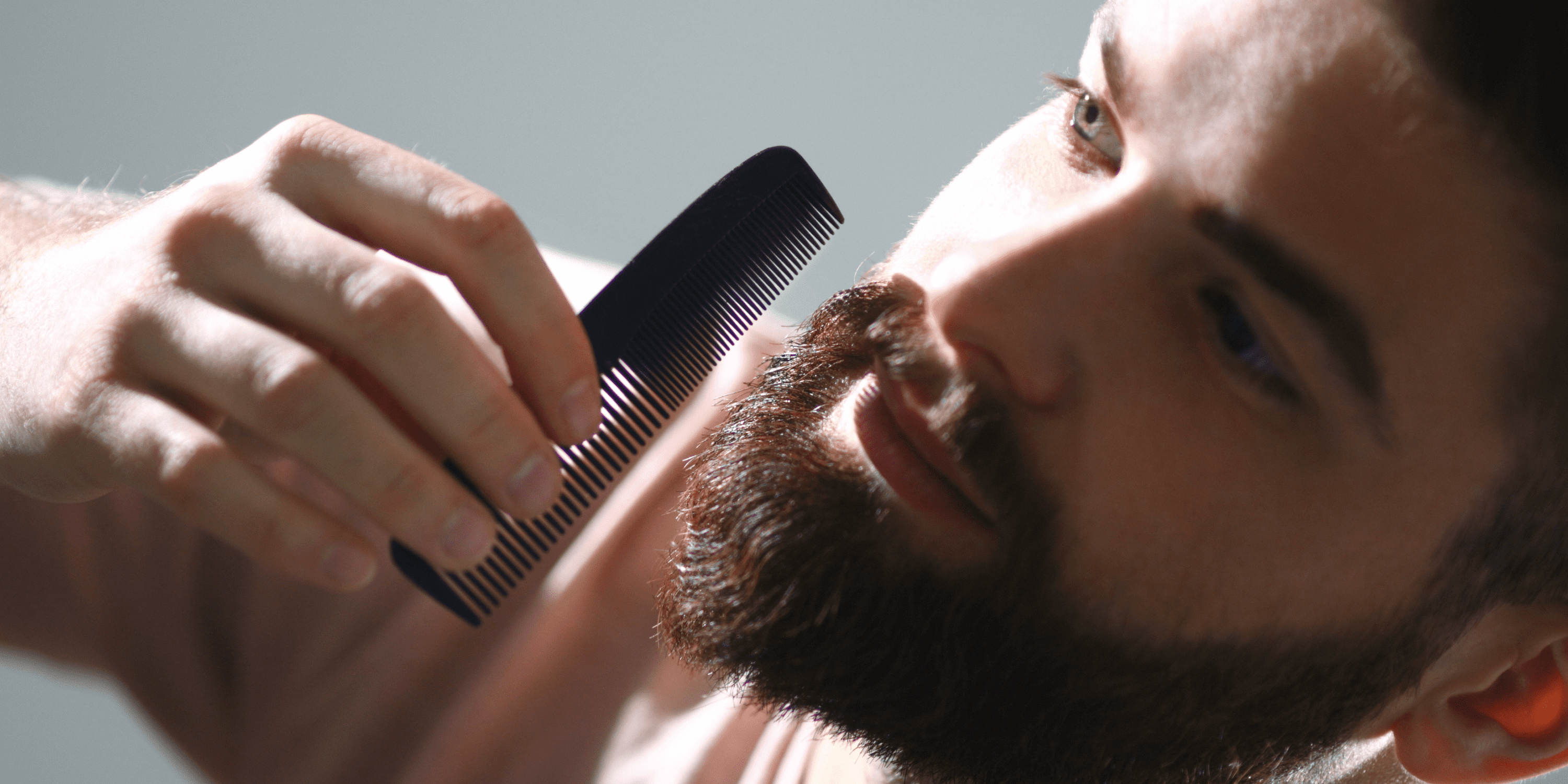 a man performing a beard grooming tips