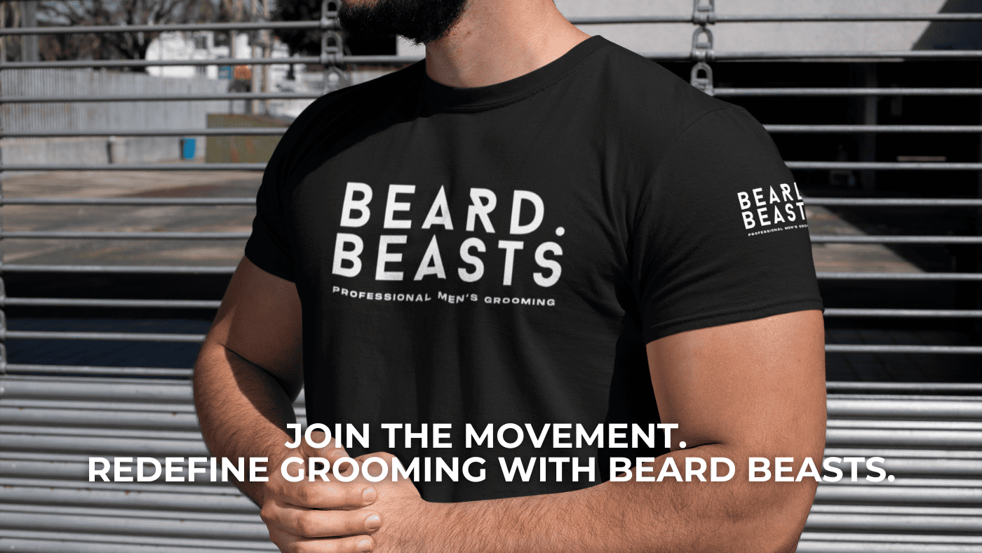 A bearded man wearing a black Beard Beasts t-shirt with the logo 'Professional Men's Grooming' displayed prominently, standing confidently in front of a modern metallic backdrop with the tagline 'Join the Movement. Redefine Grooming with Beard Beasts.