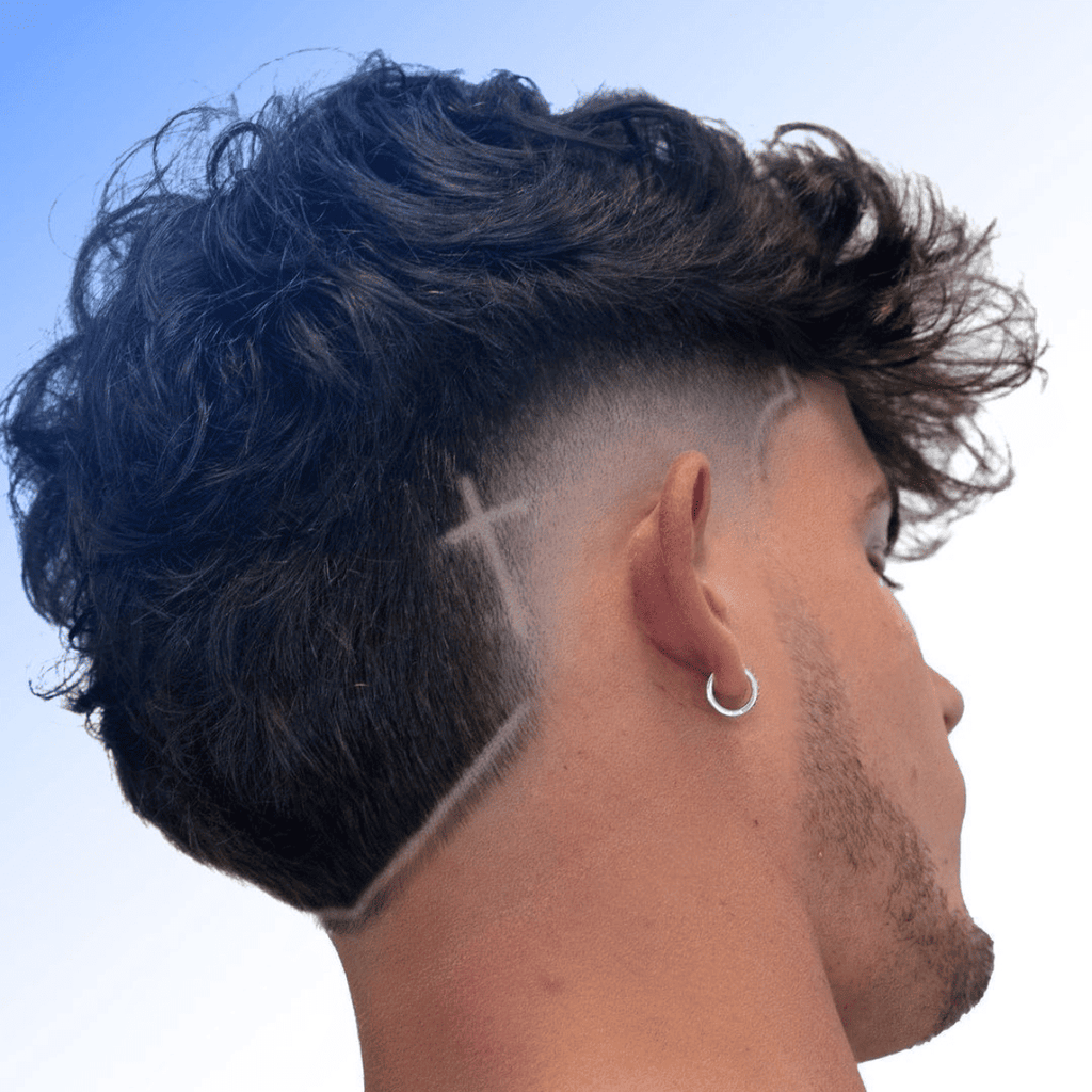 Side view of a stylish burst fade mohawk haircut with a unique cross design shaved into the fade. The hairstyle features curly, voluminous hair on top with sharp, clean edges around the fade, showcasing a bold, creative haircut.