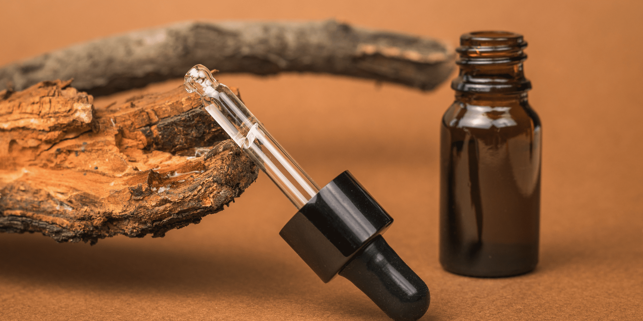 Close-up of a bottle and dropper of beard oil, debunking the common myth that beard oils and supplements can quickly grow your beard. Highlighting the benefits of beard oils for hydration and appearance, while emphasizing that they do not accelerate beard growth. Debunking myths about beard growth and effective beard care.