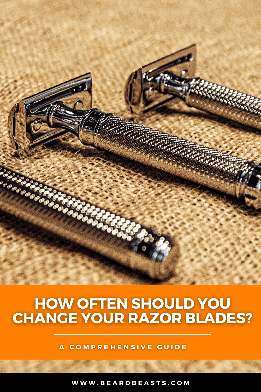 Three shiny safety razors with textured handles are laid out on a burlap surface, accompanied by text that reads "How often should you change your razor blades? A comprehensive guide" and a website URL, www.beardbeasts.com. This image emphasizes the importance of regular razor blade replacement for optimal shaving performance and hygiene.