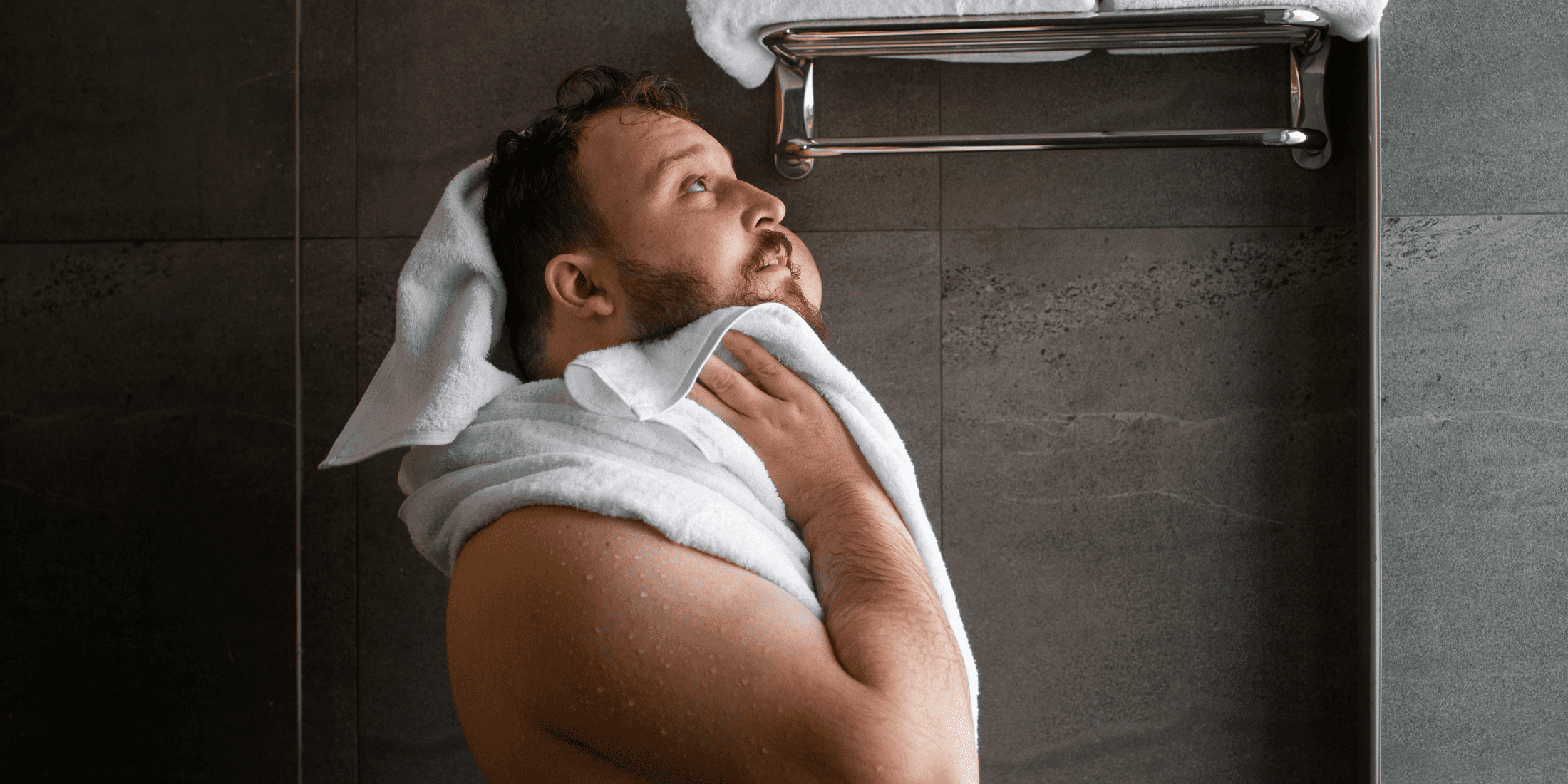 In this image, the man demonstrates an important step in beard care: drying the beard properly after washing. This visual complements our guide on how to wash your beard and highlights the importance of using the right techniques to maintain a healthy and stylish beard.