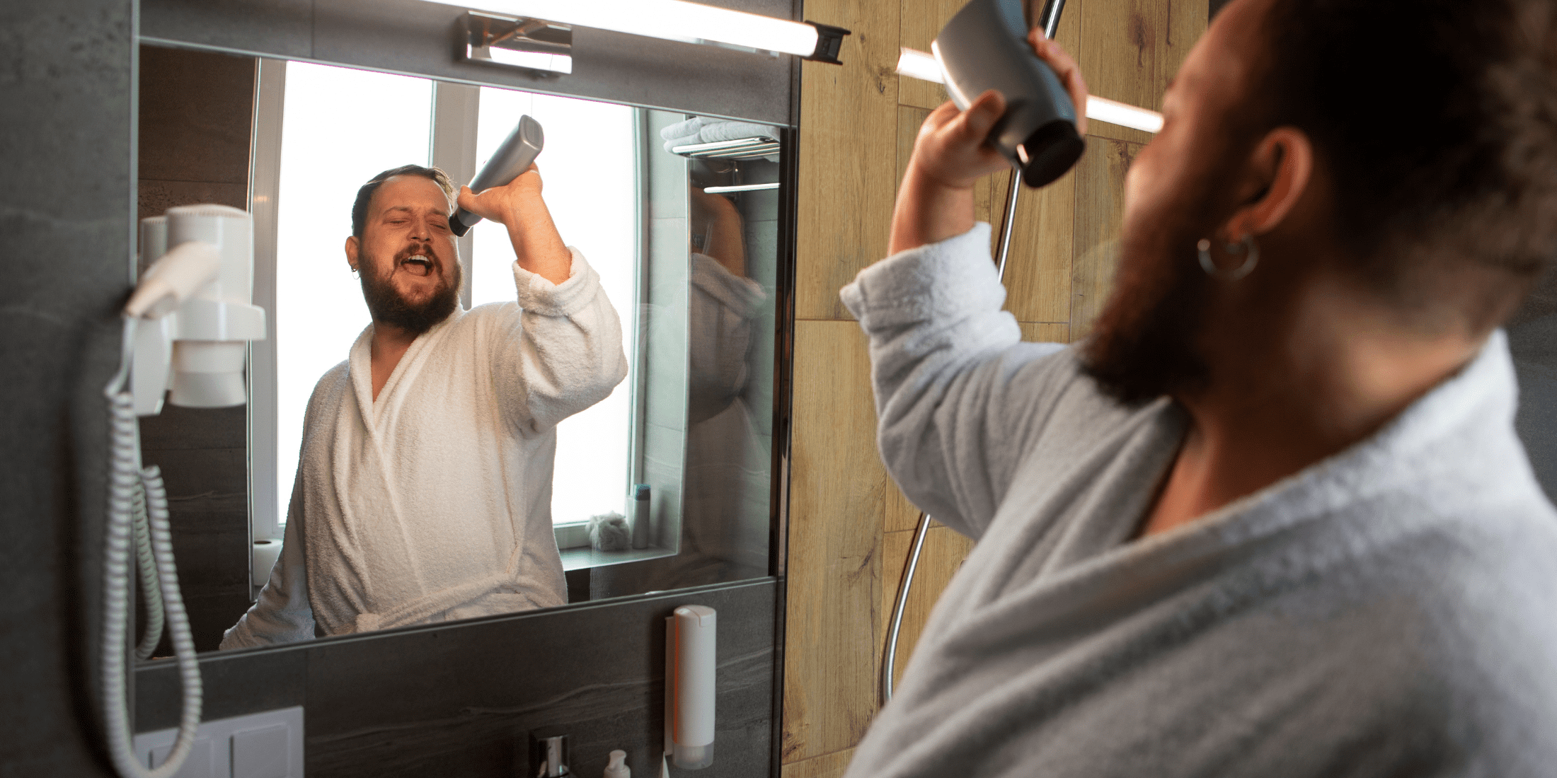 In this image, the man joyfully sings into a bottle of beard wash while standing in front of a bathroom mirror. His playful demeanor highlights the fun side of beard care and emphasizes that maintaining a healthy, clean beard can be an enjoyable part of your daily routine. This visual complements our guide on how to wash your beard and use beard wash effectively, making the process engaging and approachable.